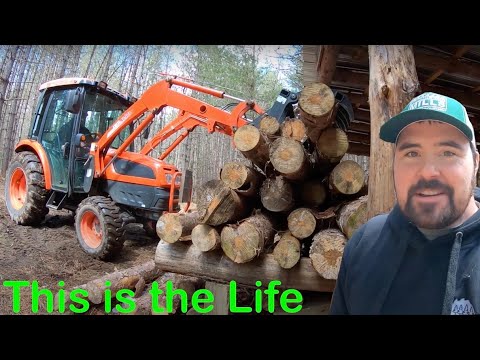 Kioti Tractor with Root Rake Grapple Moving Logs