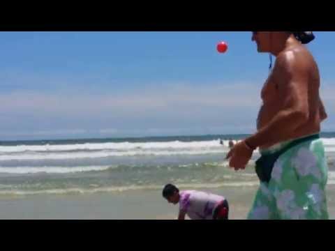 Man on the beach jogging & juggling, happy times