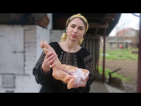 Woman is cooking traditional meat jelly in village oven. Natural Ukrainian Aspic (Kholodets)
