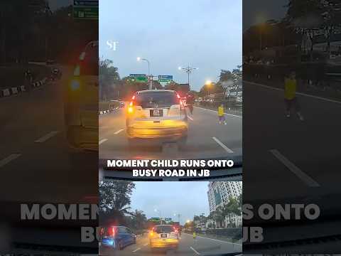 Moment child runs onto busy road in JB