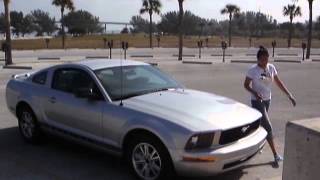 Vina opens the door of the mustang