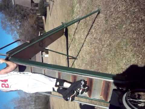 Paraplegic climbing up a slide and army half ass out.