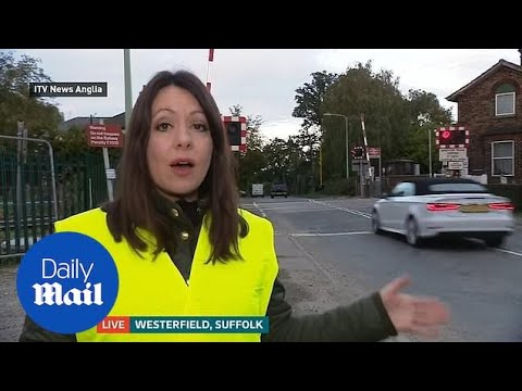 Audi driver jumps red light at level crossing on live news Suffolk