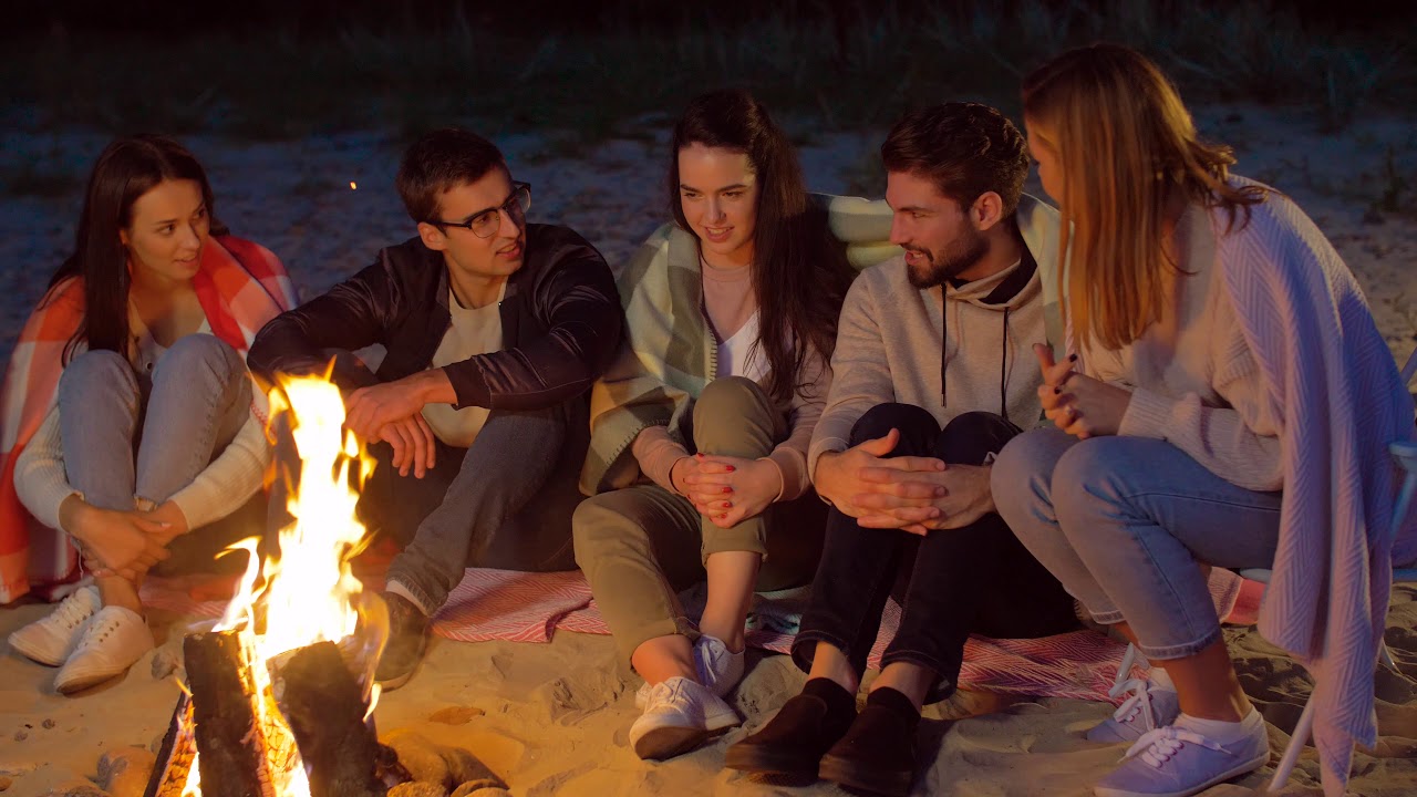 Group of Friends Sitting at Camp Fire