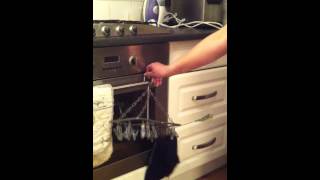 TheSeriousGuide - How To Hang Washing Utensil On Oven Containing 2 Socks