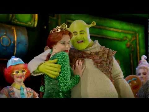 Backstage-reveal trailer frame showing costumes and Duloc spectacle moments