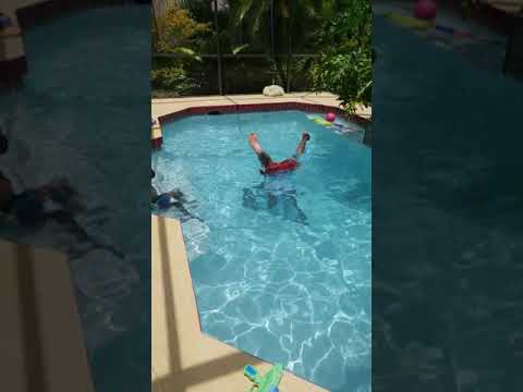 Dad teaches son to hand stand