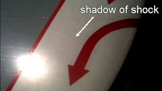 Shock wave visualized over the wing of an airplane