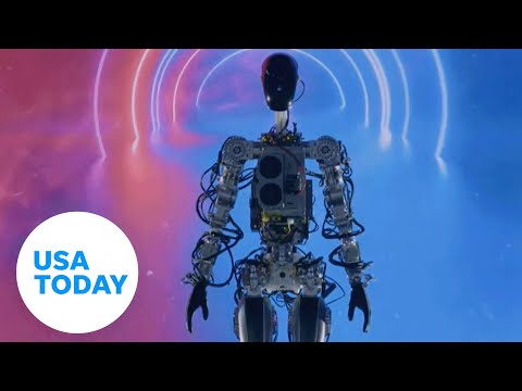 Elon Musk's humanoid robot 'Optimus' walks across the stage and waves USA TODAY