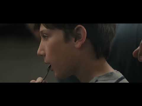 Brightburn (2019) official trailer frame: Brandon Breyer standing in the barn doorway, red cape trailing