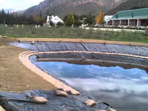 Power plastics industrial covers and liners dam liner instal...