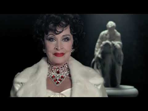2015 teaser frame: Chita Rivera as Claire Zachanassian steps from her train into the ghosted gold of Güllen