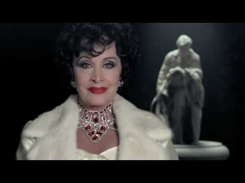 Teaser still: Claire poised with cane; the town behind her like a verdict