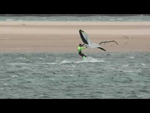 attempting to wing on a surfboard