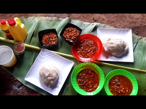 cooking palm oil sauce of popular burundian small fish with fufu (cassava flour)