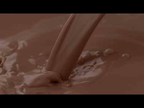 CHOCOLATE MILK BEING POURED AND MAKING BUBBLES EXTREME SLOW MOTION 4K