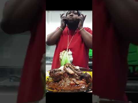 man eats spicy chicken and pulls out his braids