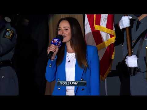 Hockey fans join Nicole Raviv in singing the National Anthem during Stanley Cup Playoffs