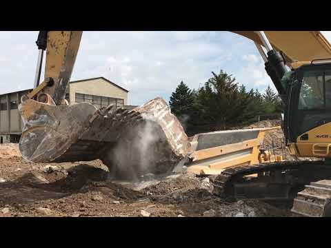 Caterpillar 385C Excavator Loading Komatsu Dumper With Huge Concrete Blocks
