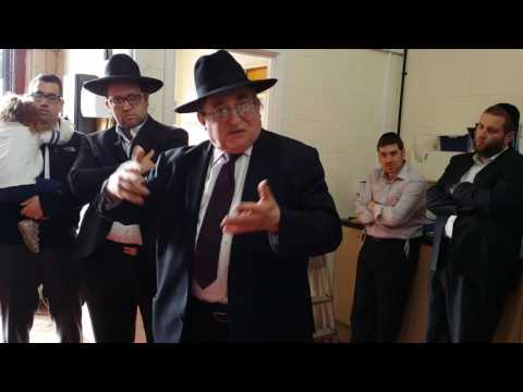 Rabbi Paysach Krohn speaking at the Misaskim warehouse in Manchester