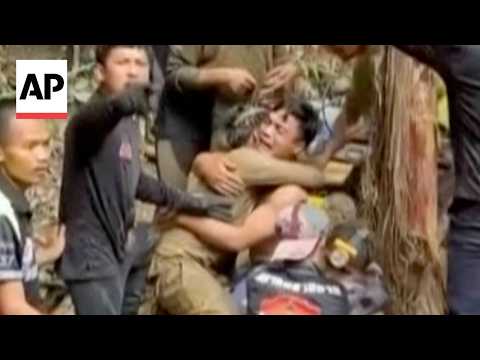 Rescuers free 4 men trapped in flooded Laos cave as 2 still missing