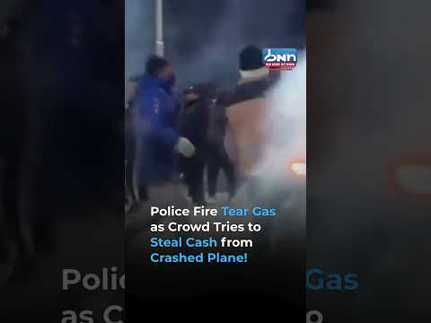 Bolivian Police Use Tear Gas as Crowds Rush to Collect Cash from Plane Crash
