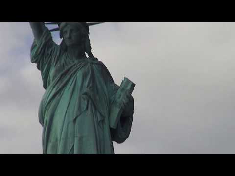 statue of liberty and tourists