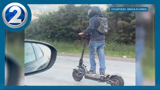 Electric scooter on freeway shocks and terrifies drivers of possible danger to himself and others