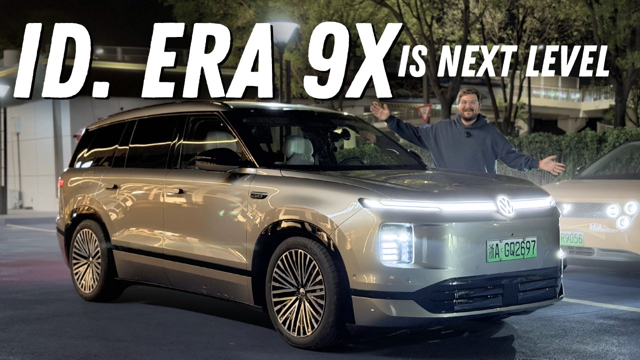 Kyle Conner from Out of Spec Reviews standing in front of the Volkswagen ID Era 9X at the Beijing Auto Show at night in the rain