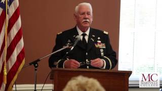 Retired U.S. Army Captain Claude Abbott speaking at a luncheon on Veterans Day