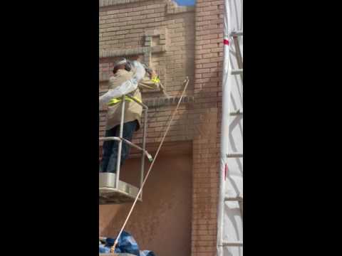 Removing coating off old historic brick Building with wet blaster