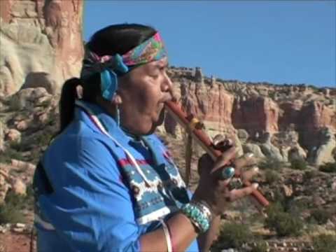 Fernando Cecillion playing his flute in front of beautiful Zuni sacred mountain, Dowa Yallane
