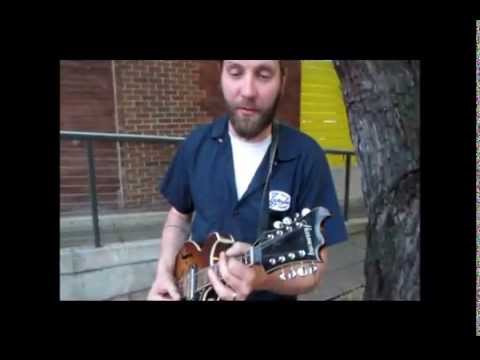 Gerry Hundt plays mandolin blues and scratchs a tree