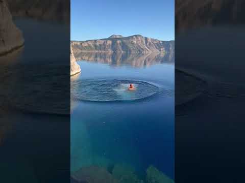 shaman jumping off rock at crater lake