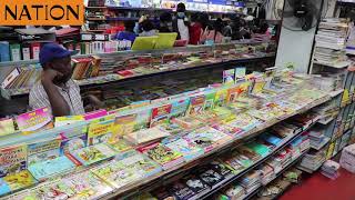 Parents and guardians buy stationery at the Savani