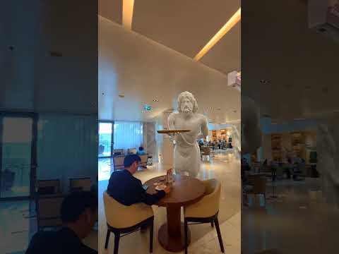 CGI statues are serving plates in a hotel lounge!