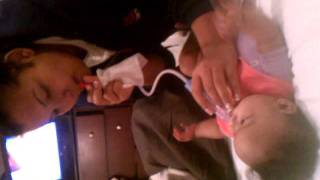 Wife sucking boogers out the baby nose...Eeewwww!!