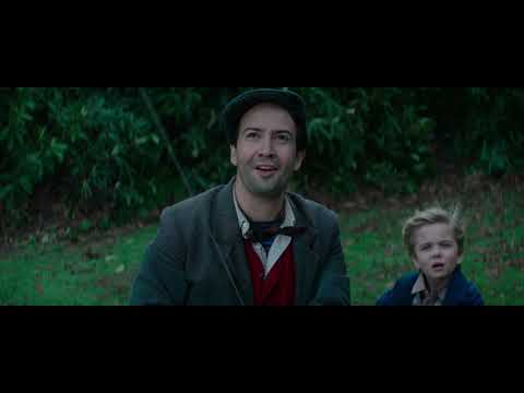 Mary Poppins Returns trailer frame of Mary holding her umbrella as balloons and kites fill the sky