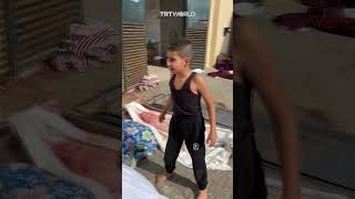 Palestinian boy looks for his family members' bodies among the dead