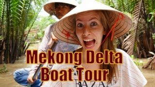 Paddling down the Mekong Delta River on a rowboat tour while wearing our conical hats in Vietnam