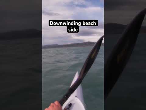 Along the beach downwinding on a Fenn elite S surf ski