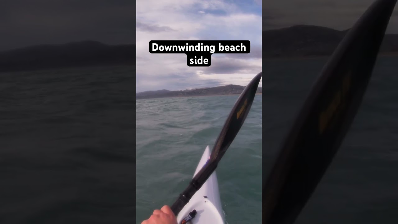 Along the beach downwinding on a Fenn elite S surf ski