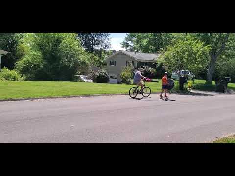 Chris skateboarding with an umbrella and a leaf blower