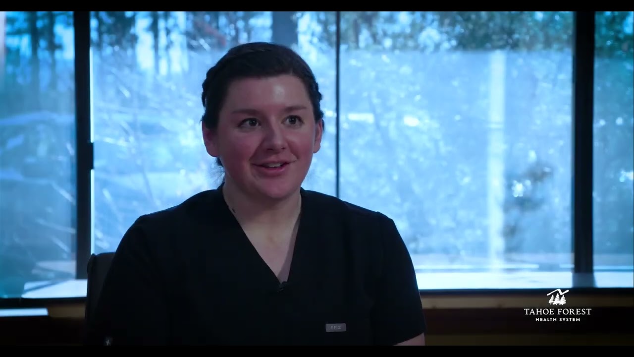 Kari Rezac, Sports Medicine Physician and Director of Sports Medicine, sitting in front of a window