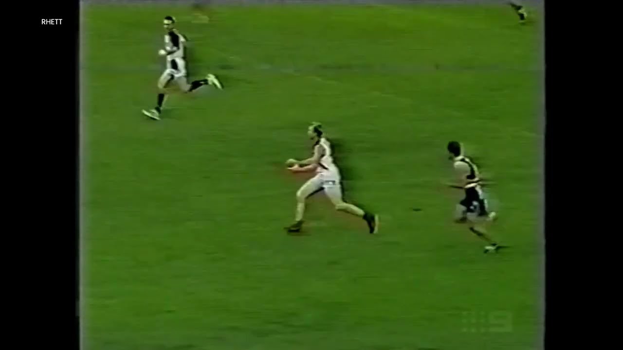 Jason Gram running from defensive 50 to kick a goal.