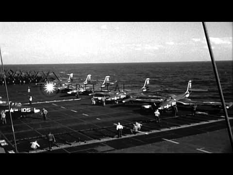 Flight deck crew respot planes aft in readiness for next launch and jets being ca...HD Stock Footage