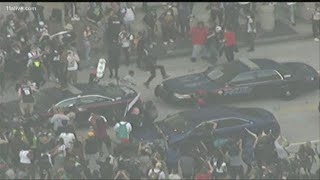 Some protesters now vandalizing police cars as some become more violent