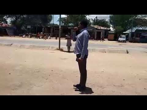 Mch. Joshua Silomba akihubiri katika mtaa mmojawapo wa Lamadi Mjini.