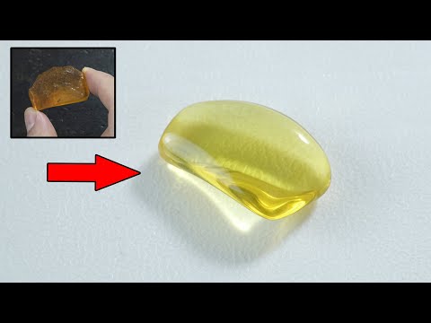 polishing an amber stone to a drop of water by hand