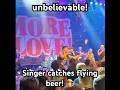 Unbelievable! Singer catches flying beer from the audience! 🍺